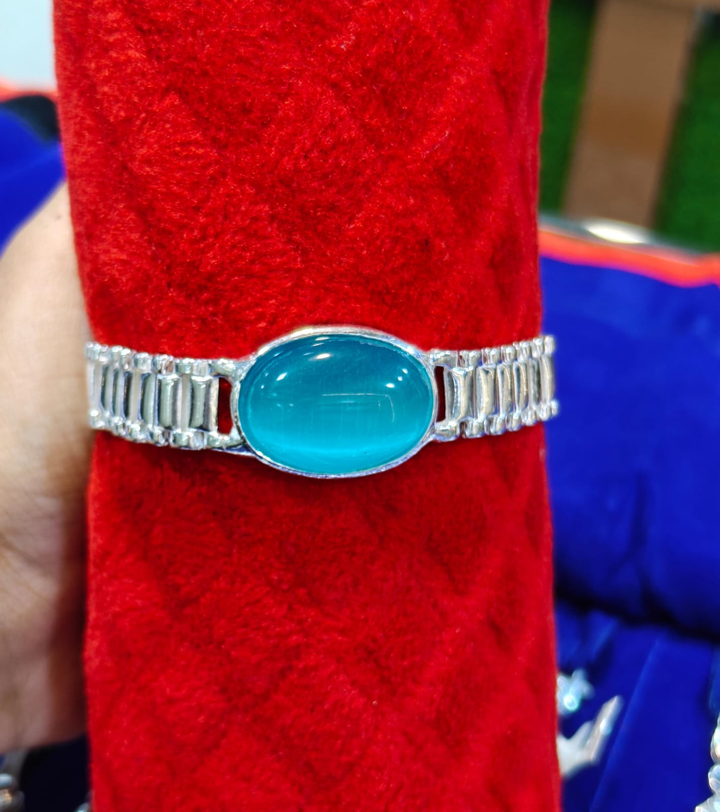 silver bracelet with an oval turquoise-blue cabochon stone