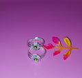 silver flower toe rings with clear rhinestones and green centers