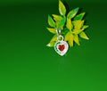 A silver heart-shaped pendant charm with a red heart in the center and small green and clear stones around the border