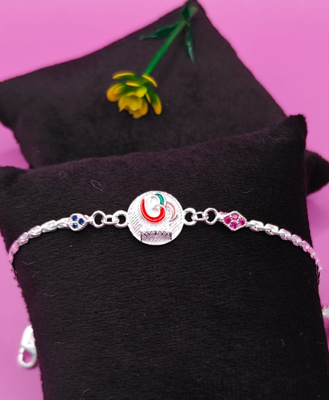 Silver Om Rakhi Bracelet with Multicolor Detailing and Studded Stones