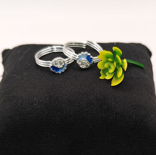 Two silver-toned toe rings with blue enamel flower charms