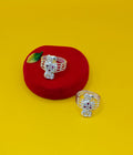 Two silver-toned toe rings with floral  set with small red and clear stones